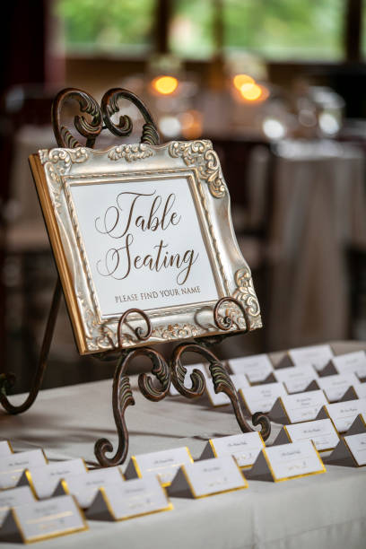 istock Folded name card in script writing and gold trim on a table for a wedding ceremony seating chart 1219052426