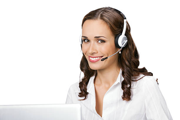 Young support phone operator in headset with laptop, isolated stock photo