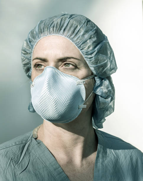 young beautiful Asian Chinese woman in protective face mask in prevention against Wuhan Coronavirus epidemic outbreak in China in virus transmission and infection concept