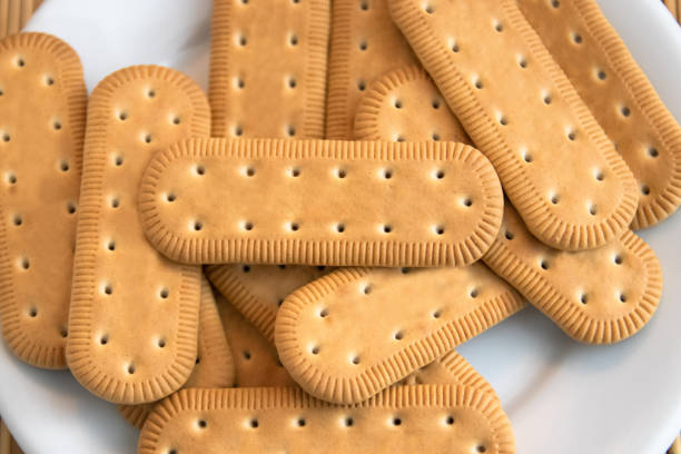 Traditional Brazilian corn starch biscuit called biscoito de maizena. Tipical cookie for afternoon coffee/tea. Corn starch biscuit on white plate