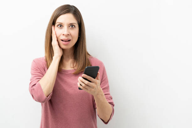 istock Shocked woman with a smartphone 1219057581