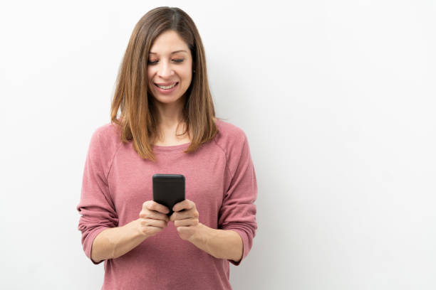 istock Beautiful woman using a smartphone 1219057585