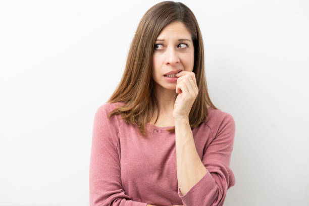 istock Nervous woman biting her nails 1219057640