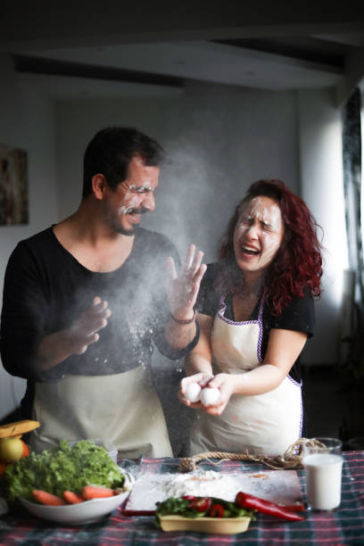 Couple Having Fun in The Kitchen, Stay At Home, Quarantine Activity At Home Couple Having Fun in The Kitchen, Stay At Home, Quarantine Activity At Home flour mess stock pictures, royalty-free photos & images