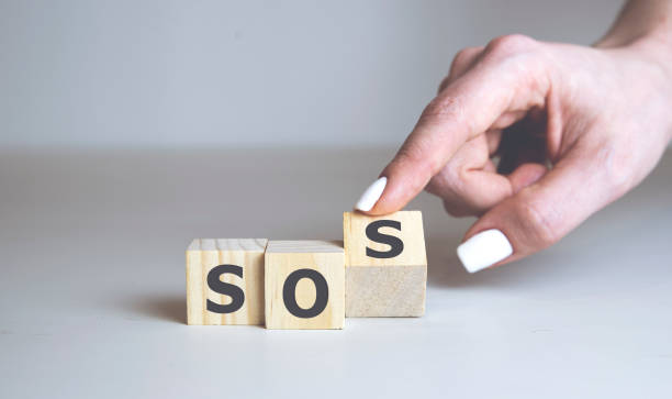 istock SOS word collected of wooden elements with the letters. SOS help concept. 1219059227