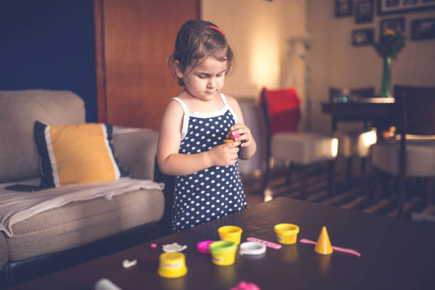 istock Cute girl playing with clay 1219059271