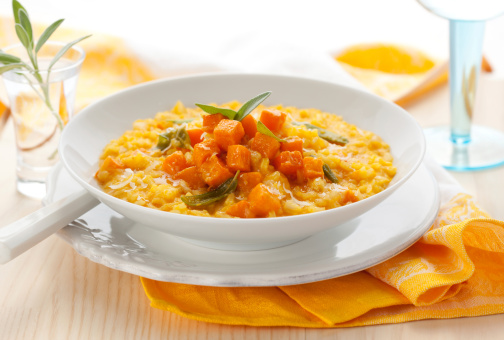 Fresh Pumpkin Soup with Pumpkin Seeds on Blue Wooden Background