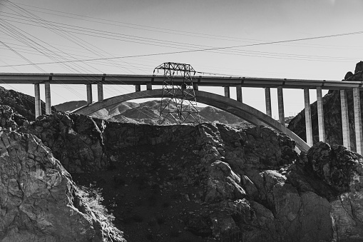 Monochromatic view of the Mike O'Callaghan - Pat Tillman Bridge Over the Colorado River in front of the Hoover Dam