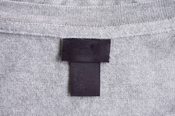 istock Blank black laundry care clothing label on fabric texture 1219063652