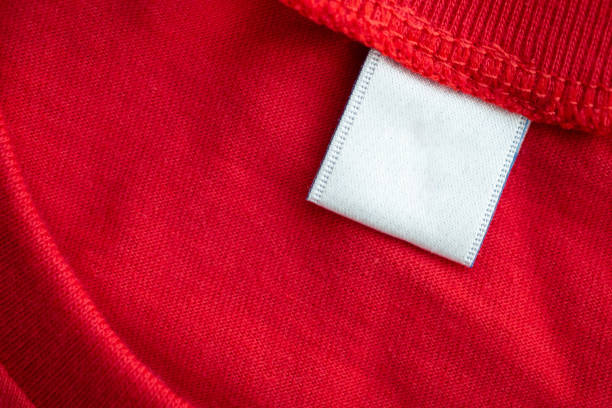 white blank clothing tag label on new red cotton shirt fabric texture background - scale industry copy space special imagens e fotografias de stock