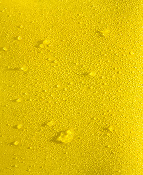 Bright yellow background with water droplets and a little bit of crushed ice