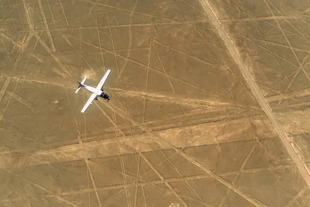 An aircraft flying over the Nazca Lines with tourists, Peru.