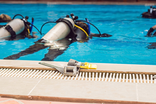 Diving instructor and students. Instructor teaches students to dive.