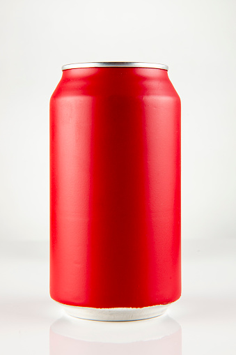 Red chilled can of soda with drops on white background and drop, in front view