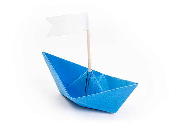 istock blue origami boat with white flag 121908489