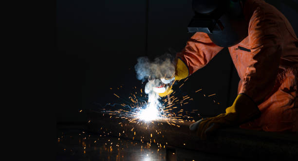 istock Metal industry workers are welding steel sheets for real estate projects received. 1219088608