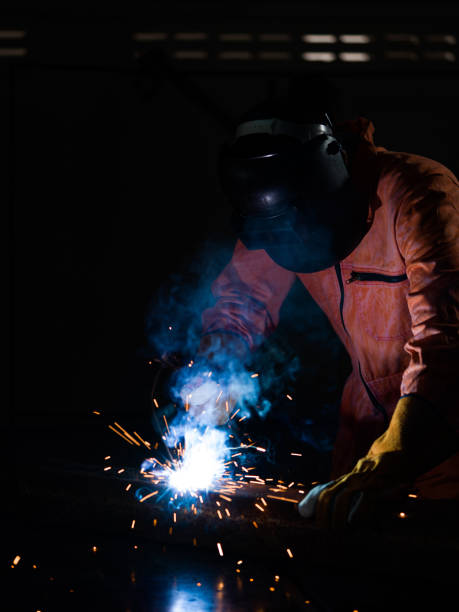 istock Metal industry workers are welding steel sheets for real estate projects received. 1219088633