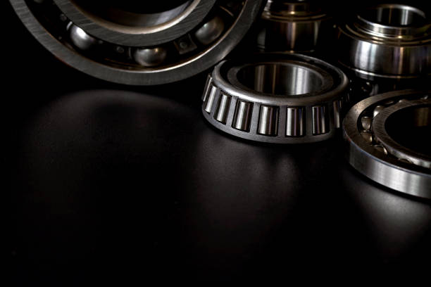 Bearings on black background. Closeup of Tapered roller bearing with copy space for your text. Spare part of mechanical on black background. ball bearing photos stock pictures, royalty-free photos & images