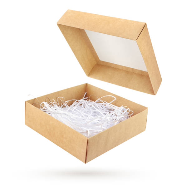 istock Open brown cardboard gift box with shredded paper isolated 1219092030