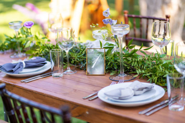 istock Preparing for an open-air party. Decorated with fresh flowers served tables. Table number. Decoration Details 1219094015
