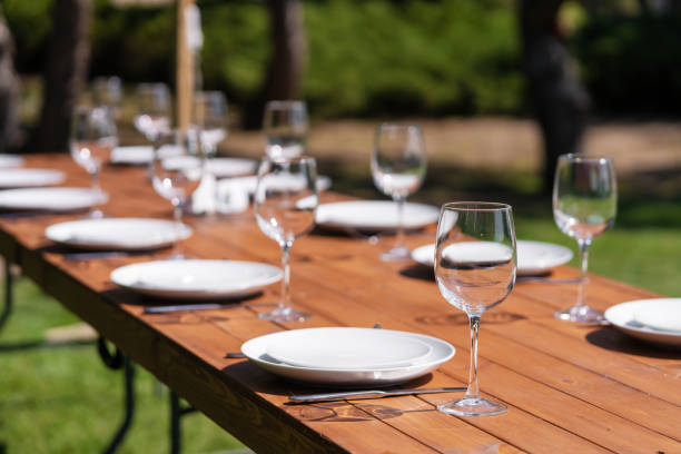 istock Served wooden table without a tablecloth. Cafe in the open air park 1219094175