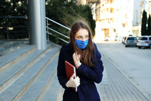 istock Young woman wearing face-protective mask and gloves 1219097996