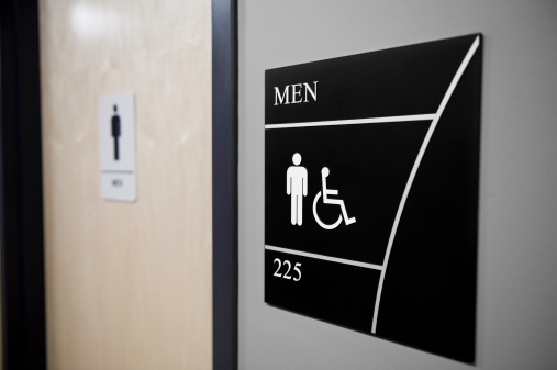 A men's restroom sign beside the door.