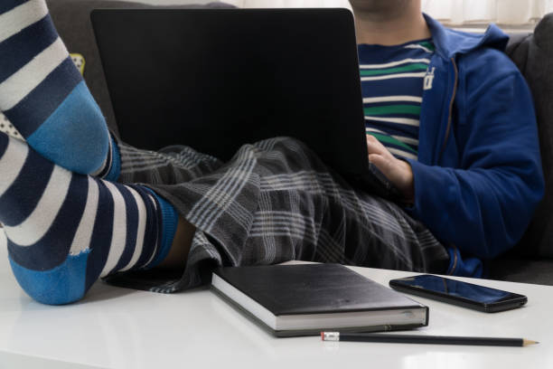 Home office concept - man working from his couch stock photo