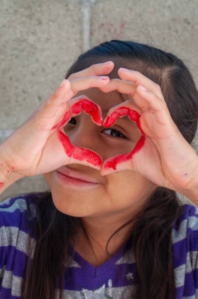 istock Girl making a heart shape with her fingers 1219101255