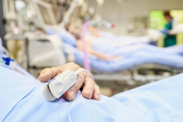 istock Blood oxymetry probe on a patient hand in intensive care unit. 1219104352