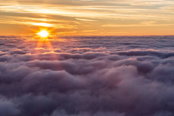 istock Sunset over a valley filled by fog like a sea 1219104932