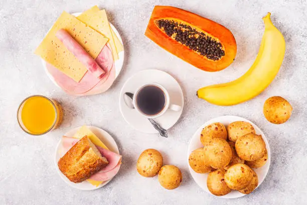 Photo of Traditional Brazilian breakfast - cheese bread, coffee, ripe fruit, top view