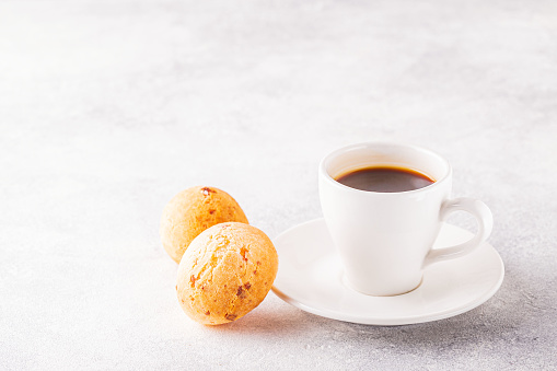 Traditional Brazilian breakfast - cheese bread and coffee, selective focus.