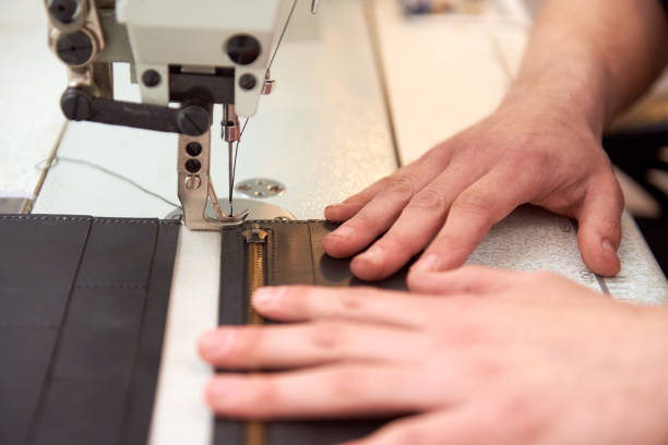 istock The leather craftsman produces leather products on sewing machine in his workshop. 1219105679