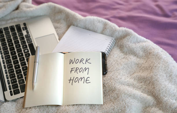 istock Work from home. Computer laptop on top of bed. 1219108871