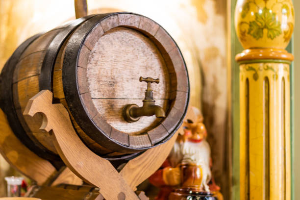 istock Old oak barrel with whiskey in front of blurred background party station setting 1219108946