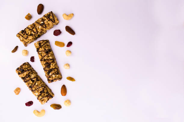 istock Useful diet granola bars. Cereal granola bar with nuts and raisins on a white background. Top view. Copy space. 1219109171