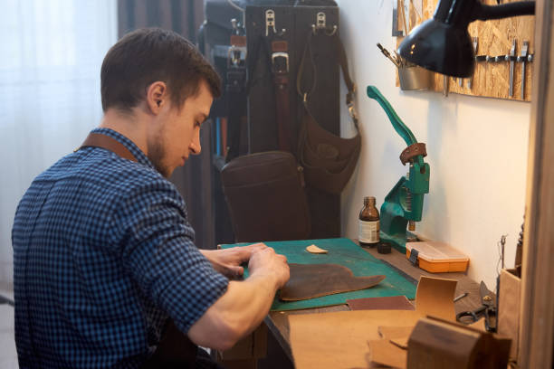 istock The leather master is dyeing natural leather at work desk. 1219110071