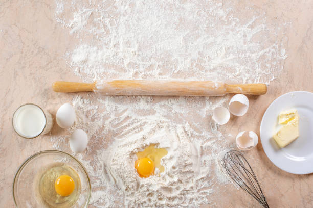 istock Kitchen table with ingredients for cooking baking. Copy space. Cooking concept. Eggs, flour on background. Dough ingredients. 1219110275