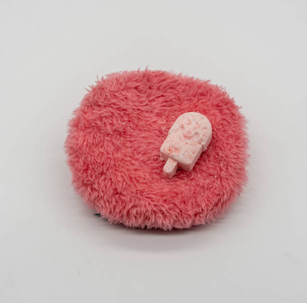 istock Cute Mini ice-cream bath bomb on red fluffy carpet like isolated on white background for valentines vibe. 1219111426