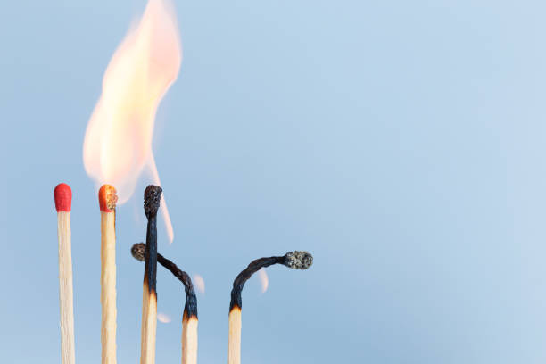 istock Matches in group burning safety-match with red, orange, yellow fire. Isolated on blue sky background detail object art 1219112795
