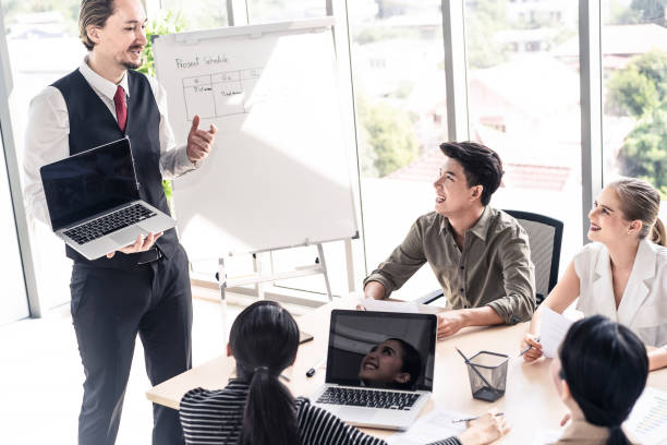 istock Group leader man and teamwork brainstorm to solve problem and presentation new idea. People conference other on new challenge topic meeting room. Business finance and communication planning concept. 1219112885