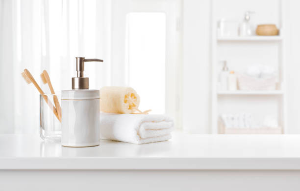 istock Soap dispenser, toothbrushes and white towel on bathroom counter interior 1219113751