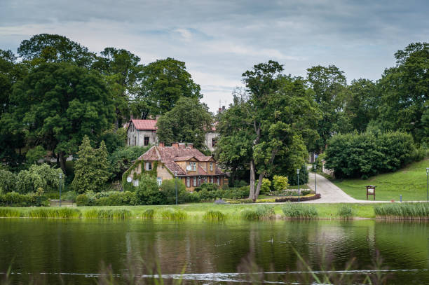 istock Old houses on the lakeside with reflection in cloudy summer day. 1219113845