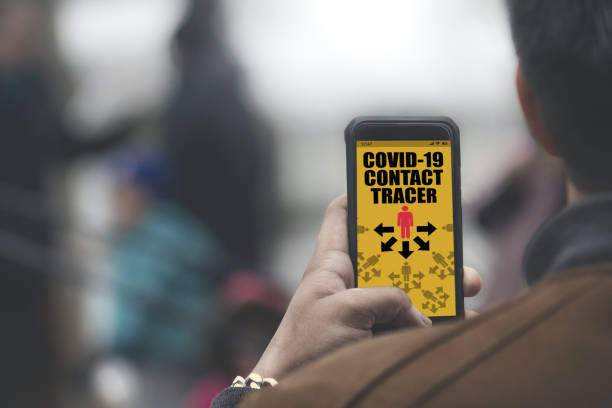 istock Covid-19 app on smartphone software in crowd of people with bluetooth notification 1219117078