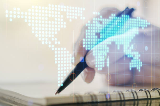 istock Abstract creative digital world map and woman hand writing in diary on background, globalization concept. Multiexposure 1219117429