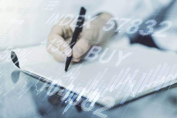 istock Double exposure of abstract creative financial chart with hand writing in notebook on background, research and strategy concept 1219117482