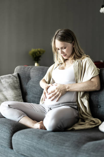 istock Serene focused expectant mother sitting on couch 1219118151