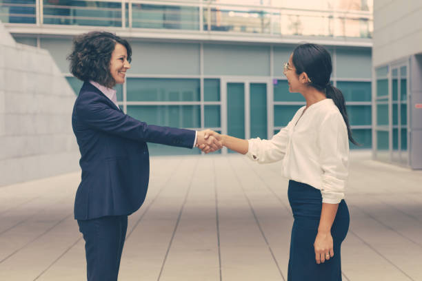 istock Happy female colleagues greeting each other 1219118953