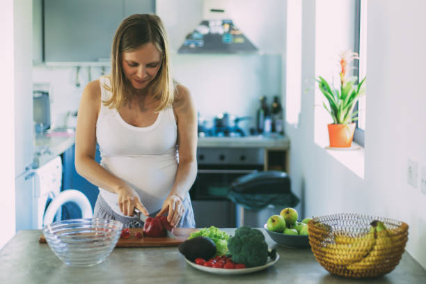 istock Focused expectant mother standing at table 1219119946